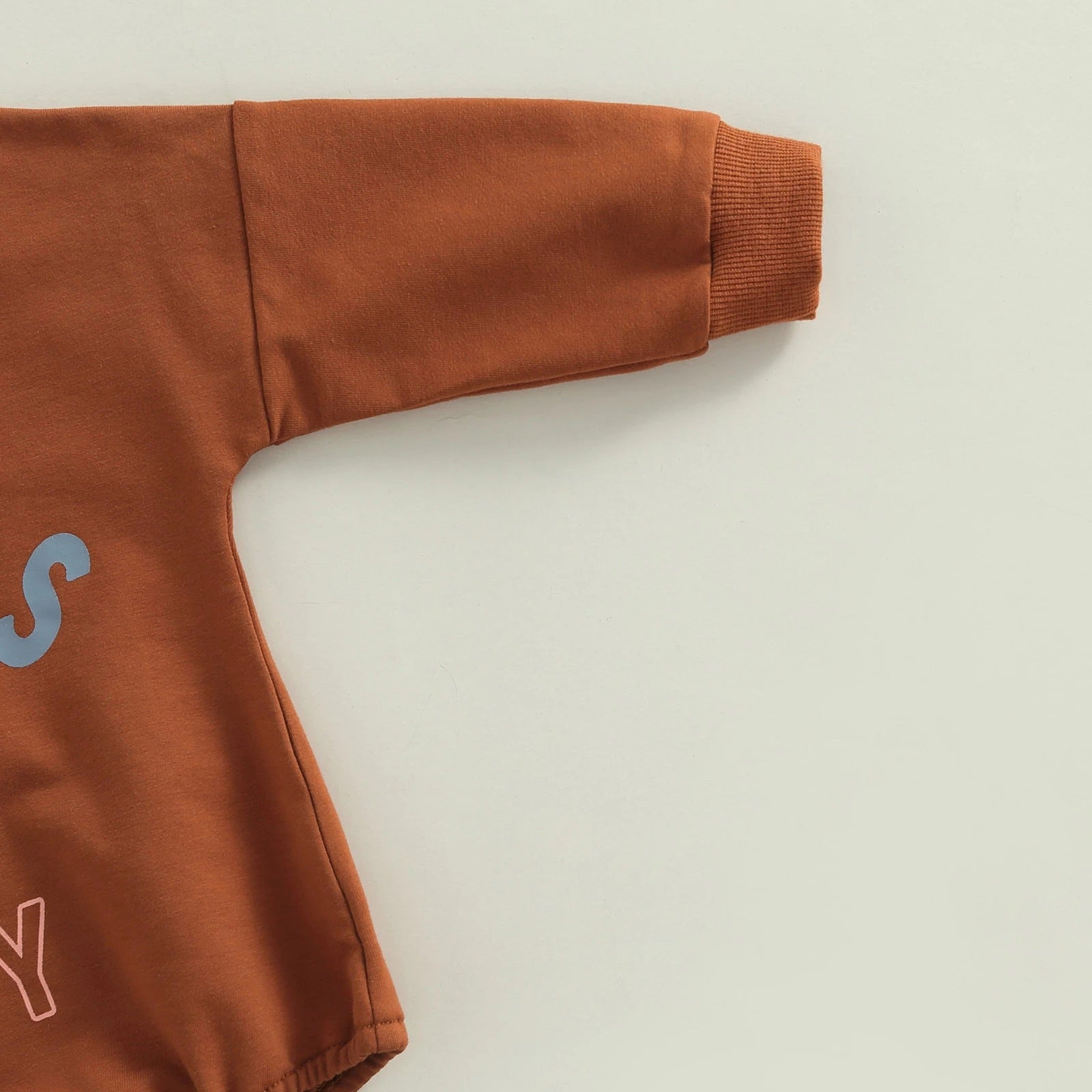Add Style and Comfort to Your Child's Wardrobe with Our Brown Lettering Printed Romper
