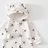 Close-up of the cream moon romper's hood with two bear ears and the top of the zip