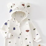 Close-up of the cream terrazzo romper's hood with two bear ears and the top of the zip
