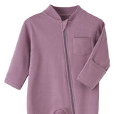 Close-up of the dusty purple romper: fabric guard at the top of the zip, chest pocket and fold-over hand cuff