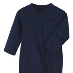 Close-up of the navy romper: fabric guard at the top of the zip, chest pocket and fold-over hand cuff