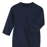 Close-up of the navy romper: fabric guard at the top of the zip, chest pocket and fold-over hand cuff