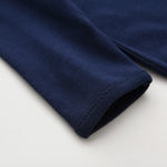 Close-up of the sleeve cuff on the navy romper