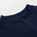 Close-up of the navy romper's stand collar and the top of the zip