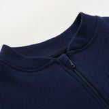 Close-up of the navy romper's stand collar and the top of the zip