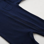 The zip running from the neck down the front of the navy romper