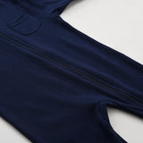 The zip running from the neck down the front of the navy romper