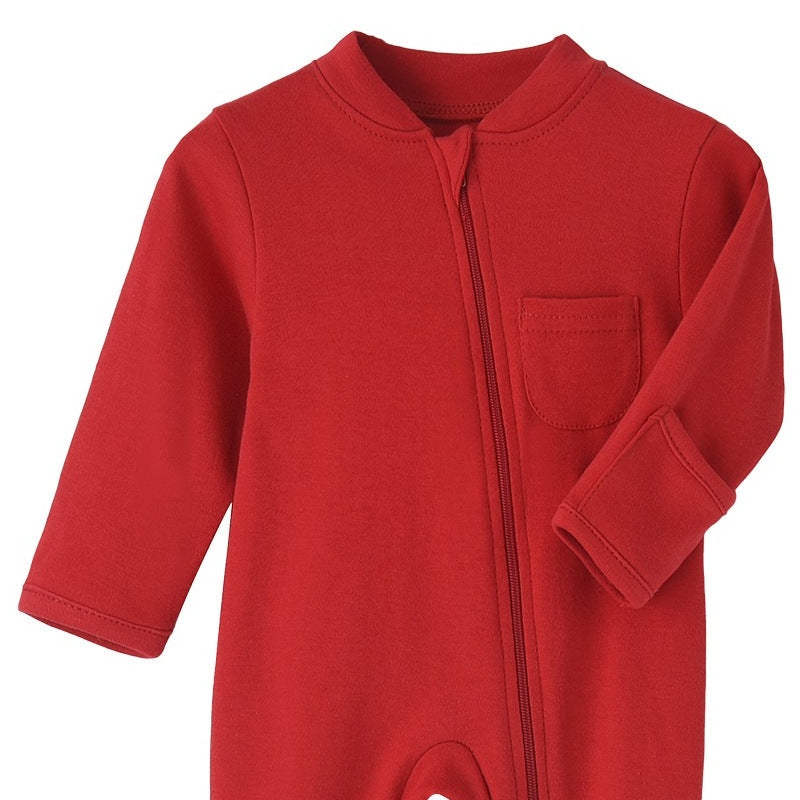 Close-up of the red romper: fabric guard at the top of the zip, chest pocket and fold-over hand cuff