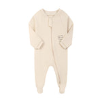 Cream little star zip baby sleepsuit with covered feet and a tab over the zip, laid flat