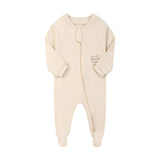 Cream little star zip baby sleepsuit with covered feet and a tab over the zip, laid flat