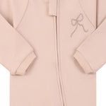 Close-up of the dusty pink embroidered bow print, the cotton jersey and the zip