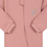 Close-up of the dusty rose flower print, the cotton jersey and the zip