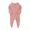 Dusty rose flower zip baby sleepsuit with covered feet and a tab over the zip, laid flat