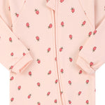 Close-up of the pink strawberry print, the cotton jersey and the zip