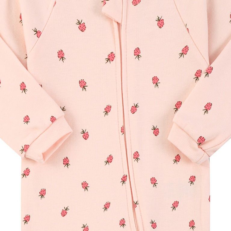 Close-up of the pink strawberry print, the cotton jersey and the zip