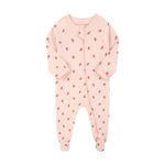 Pink strawberry zip baby sleepsuit with covered feet and a tab over the zip, laid flat