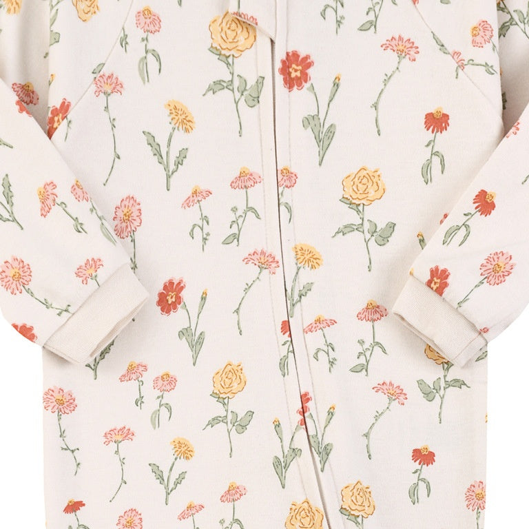 Close-up of the white garden flower print, the cotton jersey and the zip