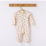 Cream Bows frill-shoulder romper on a wooden hanger, front view showing the zip down one leg and the ankle cuffs