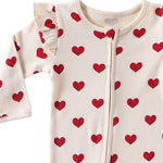 Close-up of the shoulder frill, rib texture and zip pull on the Cream Hearts romper