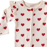 Close-up of the shoulder frill, rib texture and zip pull on the Cream Hearts romper