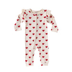 Cream Hearts baby romper with frilled shoulders and a two-way zip from the neck down one leg, laid flat, front view