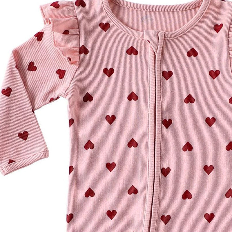 Close-up of the shoulder frill, rib texture and the top of the zip on the Pink Hearts romper