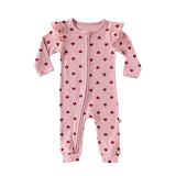 Pink Hearts baby romper with frilled shoulders and a two-way zip from the neck down one leg, laid flat, front view