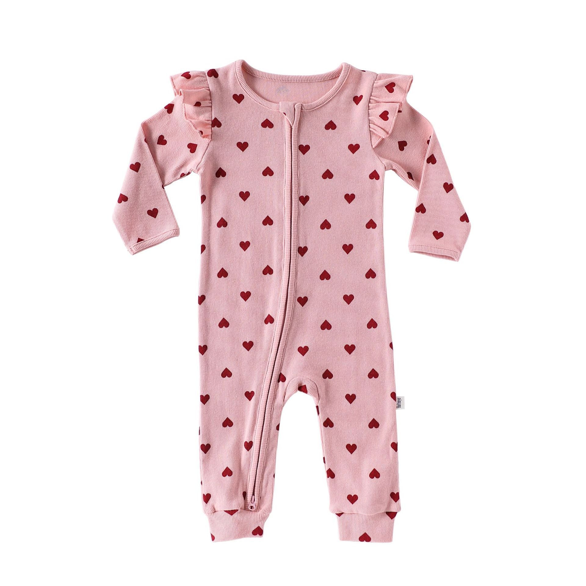 Pink Hearts baby romper with frilled shoulders and a two-way zip from the neck down one leg, laid flat, front view