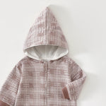 Close-up of the rose check romper's lined pointed hood and the top of the zip