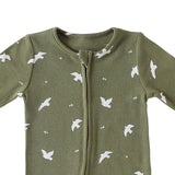 Close-up of the olive birds print, the rib texture and the fabric cover at the top of the zip