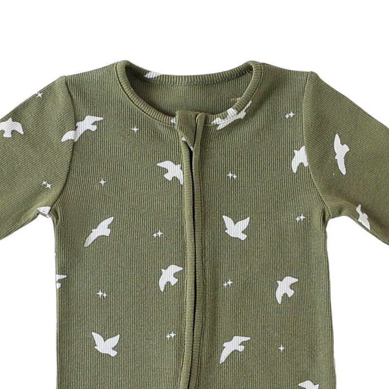 Close-up of the olive birds print, the rib texture and the fabric cover at the top of the zip
