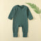 Dark Green ribbed baby romper with a zip from the neck to one ankle and fold-over cuffs, laid flat