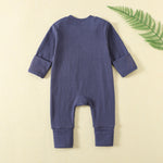 Back of the navy ribbed romper, laid flat, with both hand cuffs folded over
