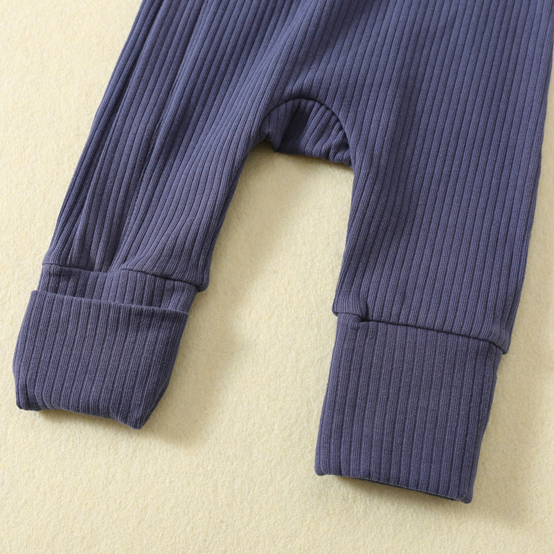 Close-up of the ankle cuffs: one turned up, one folded down to cover the foot