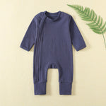 Navy ribbed baby romper with a zip from the neck to one ankle and fold-over cuffs, laid flat