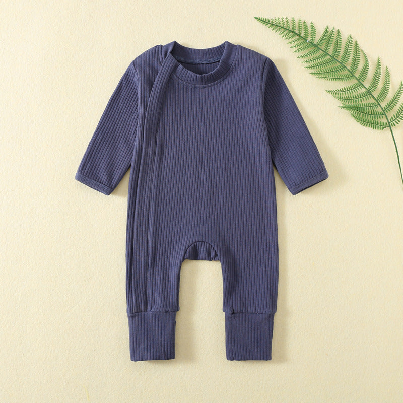 Navy ribbed baby romper with a zip from the neck to one ankle and fold-over cuffs, laid flat