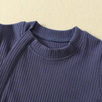Close-up of the ribbed round neck and the top of the zip strip