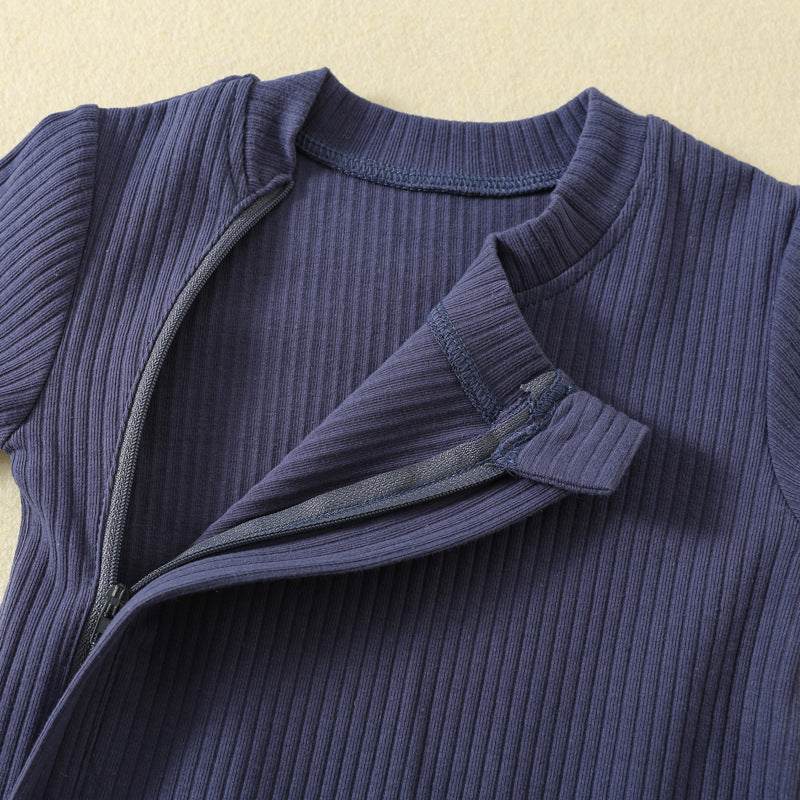 Close-up of the zip opened at the neck, under its fabric strip, with the small fabric tab at the top