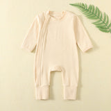 Pale Apricot ribbed baby romper with a zip from the neck to one ankle and fold-over cuffs, laid flat