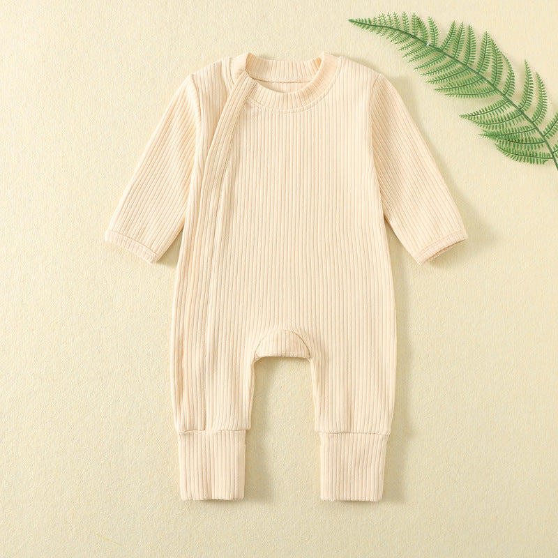 Pale Apricot ribbed baby romper with a zip from the neck to one ankle and fold-over cuffs, laid flat