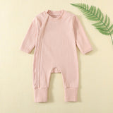Peach Pink ribbed baby romper with a zip from the neck to one ankle and fold-over cuffs, laid flat