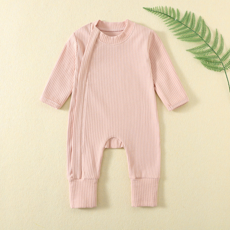 Peach Pink ribbed baby romper with a zip from the neck to one ankle and fold-over cuffs, laid flat