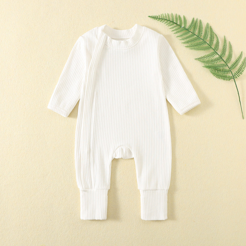 White ribbed baby romper with a zip from the neck to one ankle and fold-over cuffs, laid flat