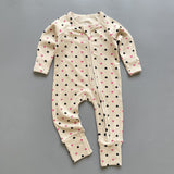 Cream pink heart ribbed zip baby sleepsuit with fold-over hand and foot cuffs, laid flat