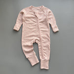 Pink red spot ribbed zip baby sleepsuit with fold-over hand and foot cuffs, laid flat