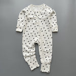White black star ribbed zip baby sleepsuit with fold-over hand and foot cuffs, laid flat