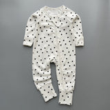 White black star ribbed zip baby sleepsuit with fold-over hand and foot cuffs, laid flat