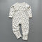 White black star ribbed zip baby sleepsuit with fold-over hand and foot cuffs, laid flat