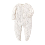 Cream Spots print baby romper with a zip from one ankle to the neck, covered feet and fold-over cuffs, laid flat