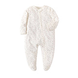 Cream Spots print baby romper with a zip from one ankle to the neck, covered feet and fold-over cuffs, laid flat